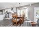 Eat-in kitchen area with wood dining table, chairs, stylish lighting, and large windows at 13131 Conner Knoll Pkwy, Fishers, IN 46038