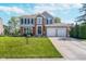 Charming two-story home with brick and gray siding, a well-manicured lawn, and a two-car garage at 13131 Conner Knoll Pkwy, Fishers, IN 46038