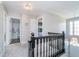 Upstairs hallway featuring hardwood railing and access to bedrooms at 13131 Conner Knoll Pkwy, Fishers, IN 46038