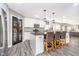 Open kitchen with stainless appliances, a large pantry, an island with seating, and sleek countertops at 13131 Conner Knoll Pkwy, Fishers, IN 46038