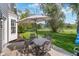 Relaxing patio area with an umbrella, table, and chairs surrounded by a lush green yard at 13131 Conner Knoll Pkwy, Fishers, IN 46038