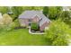 Stunning aerial view of a brick home with lush green lawn and mature trees at 13248 Blacktern Way, Carmel, IN 46033