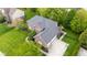 Aerial perspective of a brick house with manicured lawn, trees, and ample parking at 13248 Blacktern Way, Carmel, IN 46033