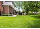 Expansive backyard showcases a well-maintained lawn, mature trees, and outdoor dining areas at 13248 Blacktern Way, Carmel, IN 46033