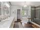 Elegant bathroom featuring double vanity, soaking tub, and a glass-enclosed shower at 13248 Blacktern Way, Carmel, IN 46033