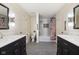 Bright bathroom boasts shiplap walls, dual vanities with gray tile flooring and a shower tub combination at 13248 Blacktern Way, Carmel, IN 46033