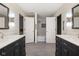 Bathroom with white shiplap, dual vanities, framed mirrors, stylish lighting, and a separate shower/tub area at 13248 Blacktern Way, Carmel, IN 46033