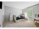 Bright bedroom featuring neutral walls, a large window with shutters, and a writing desk at 13248 Blacktern Way, Carmel, IN 46033