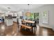 Bright dining area featuring modern lighting, neutral accents, and access to outdoor patio through sliding doors at 13248 Blacktern Way, Carmel, IN 46033