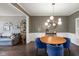 Dining room with hardwood floors, modern lighting, and blue velvet chairs at 13248 Blacktern Way, Carmel, IN 46033