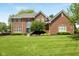 Beautiful two-story brick house with large front lawn and professional landscaping at 13248 Blacktern Way, Carmel, IN 46033