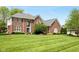 Well-maintained brick home with a lush green lawn and manicured landscaping at 13248 Blacktern Way, Carmel, IN 46033