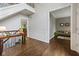 Spacious foyer with hardwood floors, staircase, and doorway leading to a cozy living area at 13248 Blacktern Way, Carmel, IN 46033