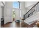 Grand foyer showcasing a large window, staircase, and front door, flooding the space with natural light at 13248 Blacktern Way, Carmel, IN 46033