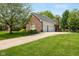 Spacious three-car garage with an extended driveway and well-kept landscaping at 13248 Blacktern Way, Carmel, IN 46033