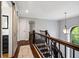 Upper hallway with hardwood floors, natural light, and a view of the staircase, providing a bright transition at 13248 Blacktern Way, Carmel, IN 46033