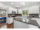 Bright kitchen featuring white cabinets, stainless steel appliances, granite countertops, and hardwood floors at 13248 Blacktern Way, Carmel, IN 46033