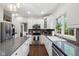 Bright kitchen featuring white cabinets, stainless steel appliances, granite countertops, and hardwood floors at 13248 Blacktern Way, Carmel, IN 46033
