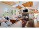 Stylish living room featuring a decorative ceiling, fireplace, and large windows for ample natural light at 13248 Blacktern Way, Carmel, IN 46033