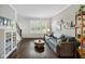 Cozy living room with hardwood floors, natural light, and comfortable seating at 13248 Blacktern Way, Carmel, IN 46033
