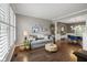 Comfortable living room with natural light, decorative shelves, and open access to dining space at 13248 Blacktern Way, Carmel, IN 46033