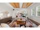 Open-concept living room offering hardwood floors, stylish decor, and seamless flow to adjacent dining area at 13248 Blacktern Way, Carmel, IN 46033