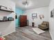 Charming room with wood floor, aqua accent wall, eclectic decorations and natural light at 13248 Blacktern Way, Carmel, IN 46033