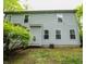 Rear exterior showcasing vinyl siding and several windows overlooking the backyard, with access to the deck at 1334 Legacy Ct, Indianapolis, IN 46234