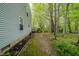 The backyard features a large grassy area with mature trees, and lush landscaping around the perimeter at 1334 Legacy Ct, Indianapolis, IN 46234