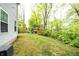 Spacious backyard with lush green grass, a play structure, and surrounding trees, creating a serene outdoor space at 1334 Legacy Ct, Indianapolis, IN 46234