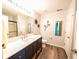 Modern bathroom with a dark vanity, white countertop, and decorative wall art at 1334 Legacy Ct, Indianapolis, IN 46234