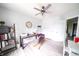 Bedroom featuring wood-look flooring, ceiling fan, desk, bookcase, and ample natural light creating a bright space at 1334 Legacy Ct, Indianapolis, IN 46234