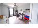 Bedroom features a ceiling fan and desk near a window, providing a bright workspace with wood-look flooring at 1334 Legacy Ct, Indianapolis, IN 46234