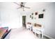 Bedroom features a ceiling fan, two white desks, and wood-look flooring, creating a comfortable workspace at 1334 Legacy Ct, Indianapolis, IN 46234