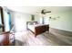 Bright primary bedroom with a dresser, ceiling fan, and wood flooring at 1334 Legacy Ct, Indianapolis, IN 46234