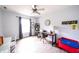 Bright bedroom with natural light, featuring a ceiling fan and wood-look flooring, and a study desk at 1334 Legacy Ct, Indianapolis, IN 46234