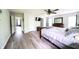Spacious primary bedroom with an ensuite, walk-in closet, ceiling fan, and wood flooring at 1334 Legacy Ct, Indianapolis, IN 46234