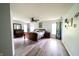 Spacious primary bedroom with a ceiling fan, wood flooring, and a dresser with a mirror at 1334 Legacy Ct, Indianapolis, IN 46234