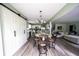 Open dining area with a modern chandelier, hardwood floors, and seamless flow into the kitchen and living room at 1334 Legacy Ct, Indianapolis, IN 46234