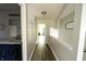 Hallway with wood floors, bathroom vanity, and inviting decor and artwork at 1334 Legacy Ct, Indianapolis, IN 46234