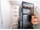 Modern laundry room featuring stacked washer and dryer with organized shelving at 1334 Legacy Ct, Indianapolis, IN 46234