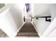 View of the wooden staircase with metal handrail leading upstairs, complemented by white walls at 1334 Legacy Ct, Indianapolis, IN 46234