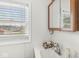 Bathroom featuring a sink with medicine cabinet and a window with blinds at 1391 N Shadeland Ave, Indianapolis, IN 46219