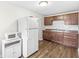 Traditional kitchen with wooden cabinets, laminate countertops, and stainless steel appliances at 1391 N Shadeland Ave, Indianapolis, IN 46219