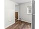 Kitchen area with wood floors, white walls, and view into other rooms at 1391 N Shadeland Ave, Indianapolis, IN 46219