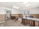 Spacious office with wood paneled walls and multiple desks with stone countertops at 1391 N Shadeland Ave, Indianapolis, IN 46219