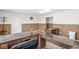 Office featuring multiple desks with stone countertops, wood paneled walls, and neutral carpet at 1391 N Shadeland Ave, Indianapolis, IN 46219