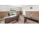 Office area featuring multiple desks with stone countertops and wood paneled walls at 1391 N Shadeland Ave, Indianapolis, IN 46219