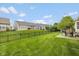 Well-manicured back yard features an iron fence, lush lawn and outdoor patio seating at 14018 Powder Dr, Carmel, IN 46033