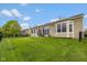 Spacious backyard features green lawn, patio area with seating, and black metal fencing at 14018 Powder Dr, Carmel, IN 46033